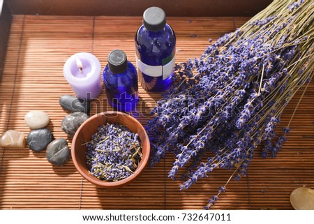 lavender with herbal ball. ,petals in bowl oil ,stones, candle for massage spa