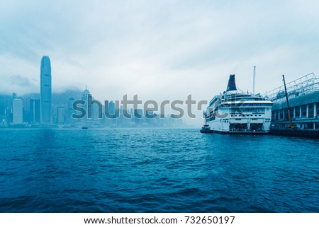 hong kong skyline with sailing boat under cloudy sky,china.
