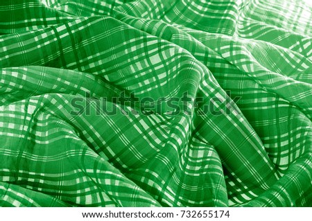 background texture. silk fabric checkered green white. beautiful silk taffeta-twill with wicker check in the "eternal bell" of green and orchid.