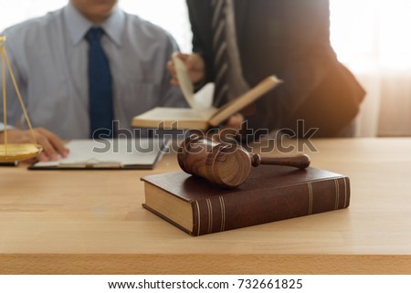 Judge gavel, law books with lawyer team meeting at law firm in background. Concepts of law,legal, ligislation.