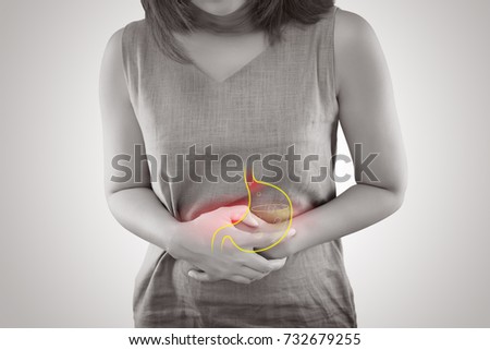 Woman suffering from gastroesophageal reflux disease or Acid reflux standing against gray background, Female Anatomy Concept Royalty-Free Stock Photo #732679255