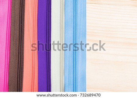 background of colored bright zippers for clothes and fabrics