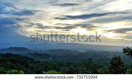 sunrise at punthuk setumbu with borobudur and merapi mountain as a background Royalty-Free Stock Photo #732711004