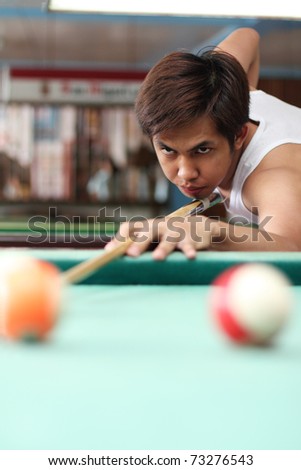 Billiard player in deep concentration