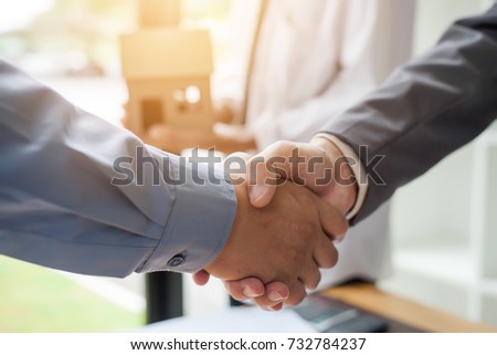 Business man shaking hands during a meeting in the office, Signing of the real estate sale agreement between buyer and broker