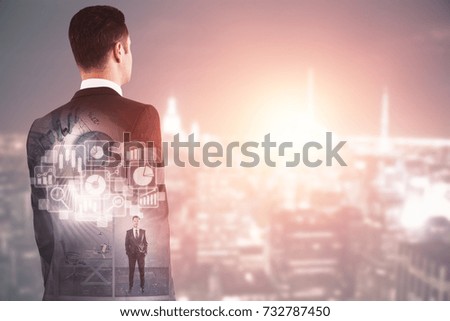 Back view of thoughtful young businessman standing on abstract city backgroound with digital business hologram and copy space. Technology concept. Double exposure 