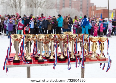 A lot of golden cups for ski championship are on table. Olympic reserve junior sports school