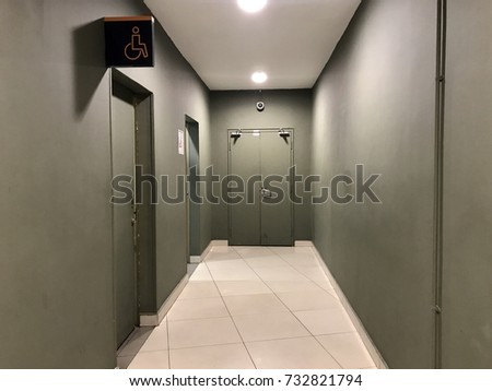 an empty space hallway to secret room with disable sign on the left