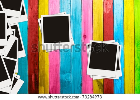 blank photos on vintage multicolored wooden background