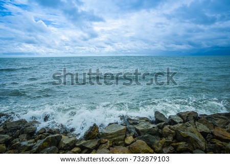 Beach with rocks and a cloudy sky for the background.