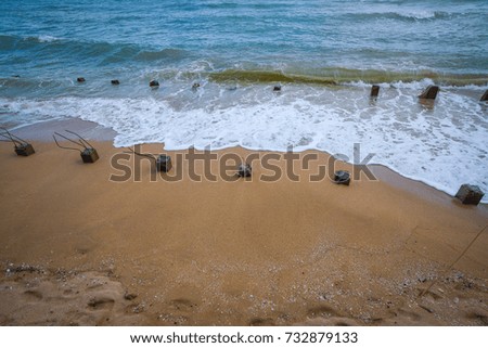 Beach with rocks and a cloudy sky for the background.