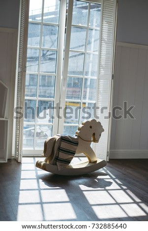Wooden Chair Rocking Horse toy near the window