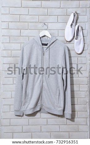 hoodie shirts hanger ,shoes isolated on wall background