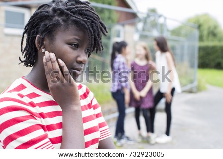 Sad Teenage Girl Feeling Left Out By Friends Royalty-Free Stock Photo #732923005
