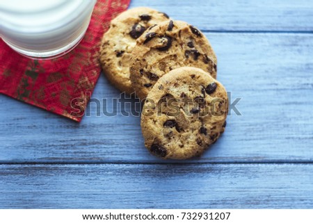 Biscuits with milk. Cookies with chocolate and milk on a wooden background. Christmas cookies