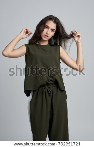 woman in stylish clothes on a light background                               