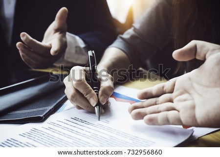 Close up business people reaching out sheet with contract agreement proposing to sign.Full and accurate details, individual who owns the business sign personally,director of the company, solicitor.
