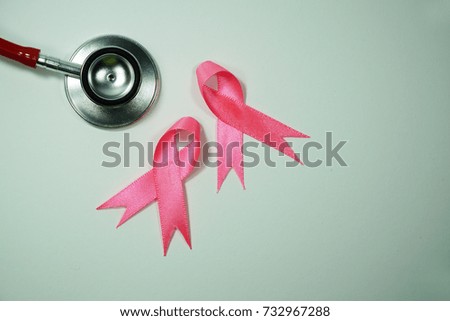 Health care and Medicine Concept - A Stethoscope and a pink ribbon over a white background. Breast cancer awareness pink sign symbol for help illness people