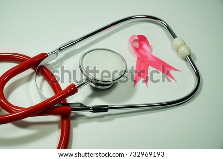 Health care and Medicine Concept - A Stethoscope and a pink ribbon  over a white background. Breast cancer awareness pink sign symbol for help illness people