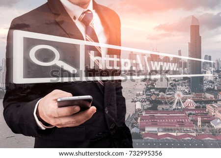 The abstract image of business man point to the hologram on his smartphone and blurred cityscape is backdrop. the concept of communication network cyber security internet of things and seo.