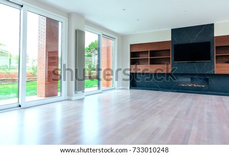 Large living room empty with fireplace and TV
