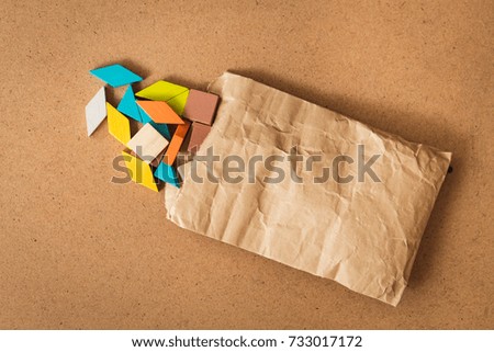 Tangram puzzle in paper bag using for business and education concept