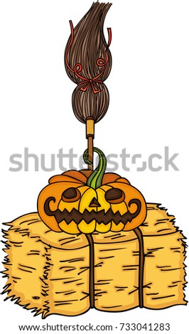 Halloween pumpkin with witch broom on bale of hay
