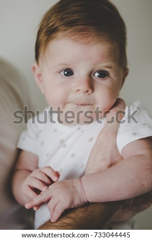 close picture of beautiful little baby girl looking on camera