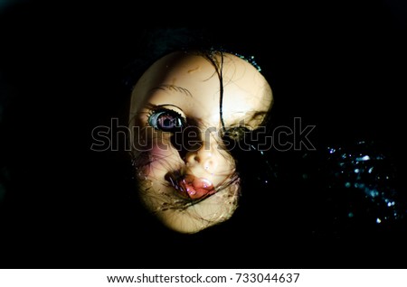 creepy doll face in the water and high contrast