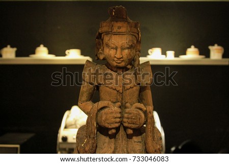 Chinese wooden doll in coffee corner in hotel.