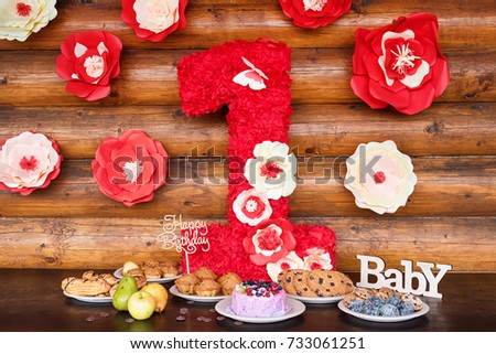 Birthday cakes and muffins with wooden greeting signs on rustic background. Wooden sing with letters Happy Birthday, Baby and holiday sweets.
