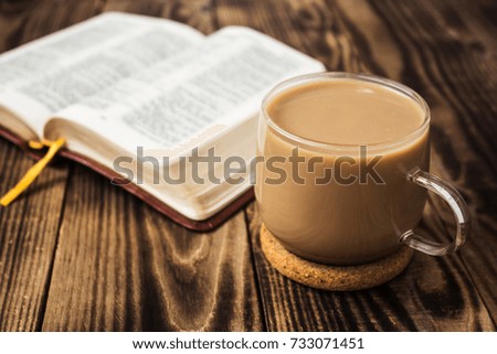 cup of coffee and bible on wooden background Royalty-Free Stock Photo #733071451