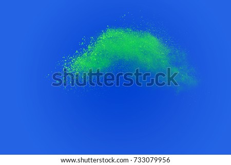 Colored powder explosion on blue background