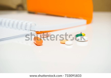 Medical pills and capsules with note book. Medical health and science concept.