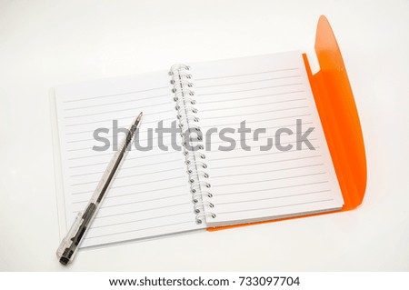 Note book with pen on white floor
