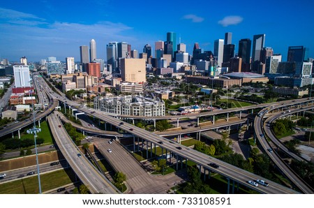 Mega city of Houston , Texas aerial drone view across interstate , turnaround , and over pass , infrastructure and transportation highways with tall skyscrapers downtown metropolis