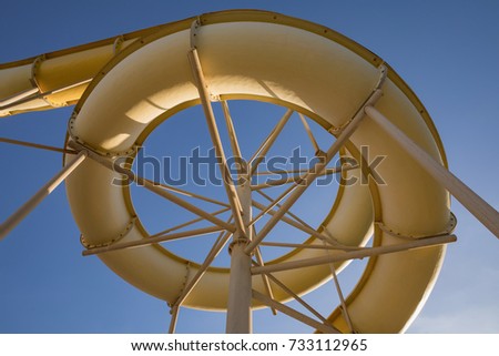 Waterpark in luxury tropical resort, water slide on blue sky, detail