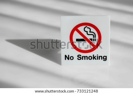 no smoking sign on the desk and shadow