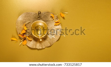 A beautiful golden Diwali Lamp and flower background with clear space for headline and text.