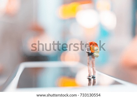 Miniature backpacker , Tourist people standing on smartphone , Travel concept