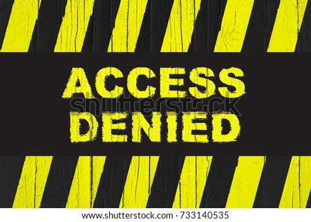 Access denied warning sign with yellow and black stripes painted on cracked wood. 
Meaning do not enter the area, caution, danger, access not granted, entrance not allowed