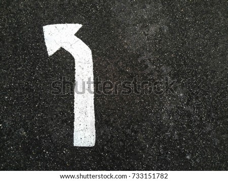 turn left white arrow sign on road with copy space