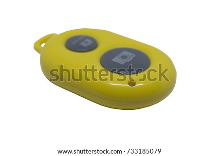 Yellow remote control camera shutter system for smartphones isolated on a white background.