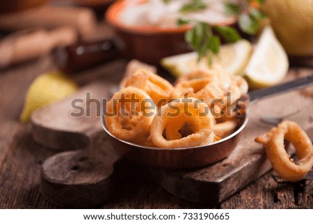 Fried calamari squid on wooden table 