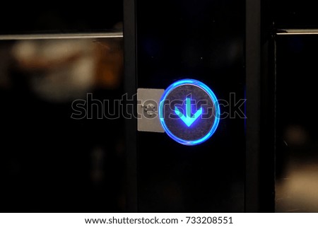 Down Arrow on Lift Button with Blue Light at Night