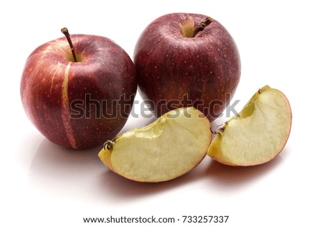 Two whole Gala apples and slices isolated on white background
