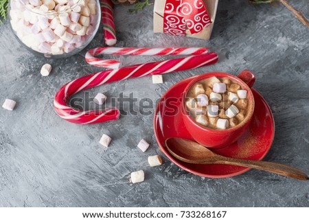 Christmas traditional hot drink  cocoa in red cup,  fir branches and  pine cones on the grey background Christmas evening Christmas card Holiday Concept,  copy space
