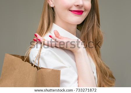 Woman hand holding shopping bags, isolated