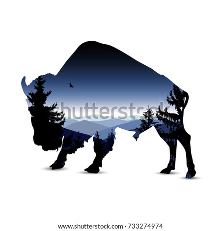 Silhouette of bull with blue evening mountain landscape.