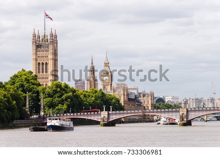 Big Ben, Westminster Bridge, and a red Double Decker Bus crossing over the bridge.